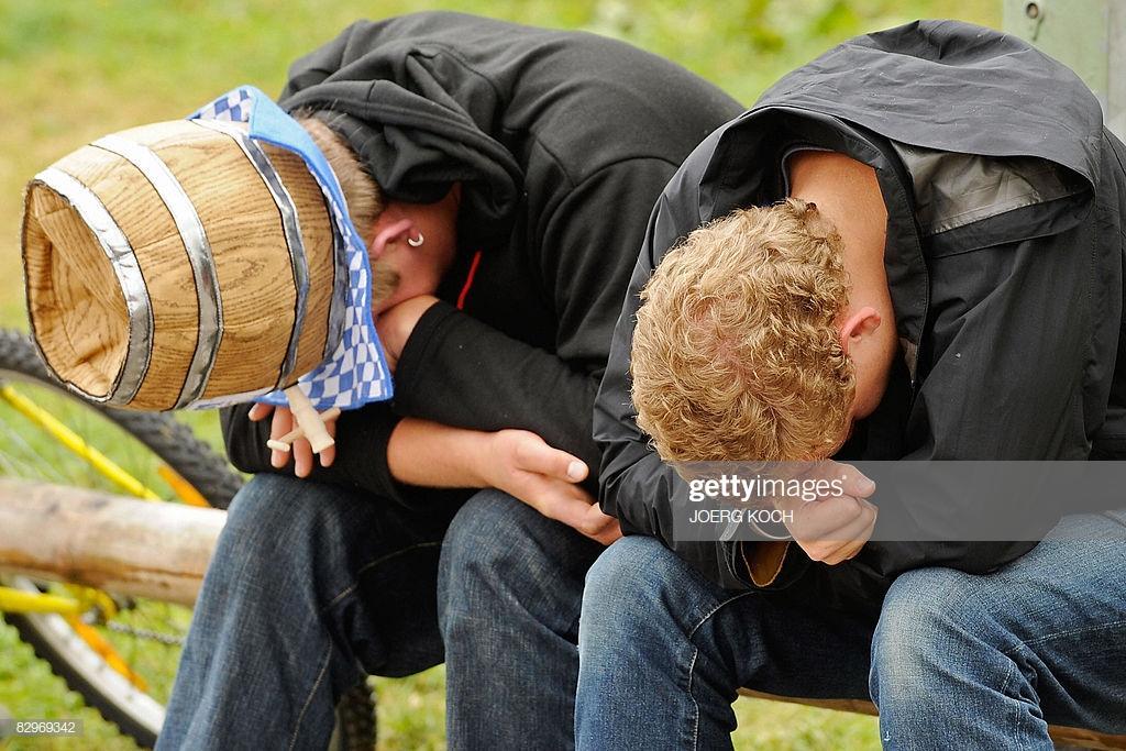 two-young-men-one-wearing-a-hat-looking-